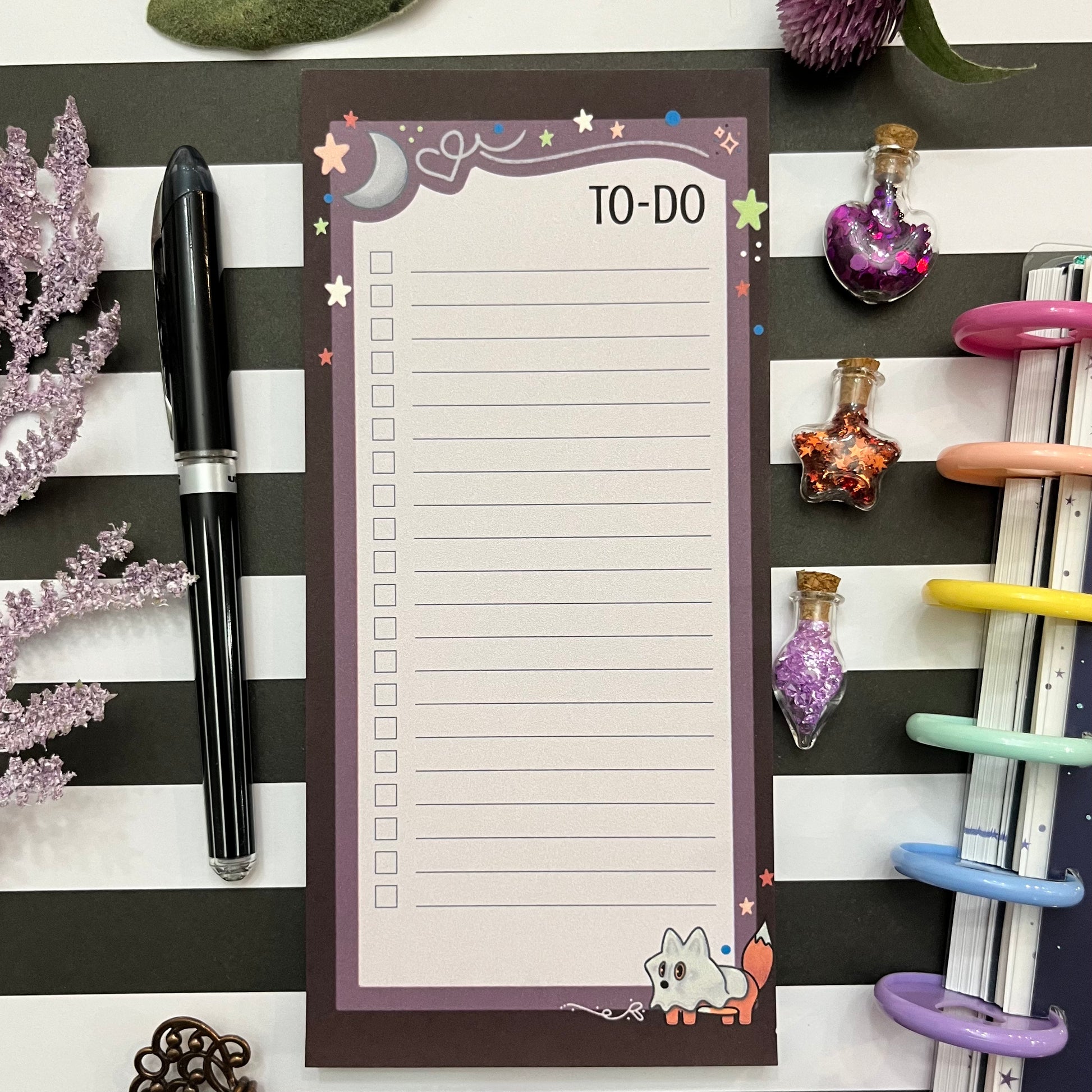 A decorative to-do notepad with a purple border, moon and stars illustration, and Maple the Fox dressed as a ghost at the bottom