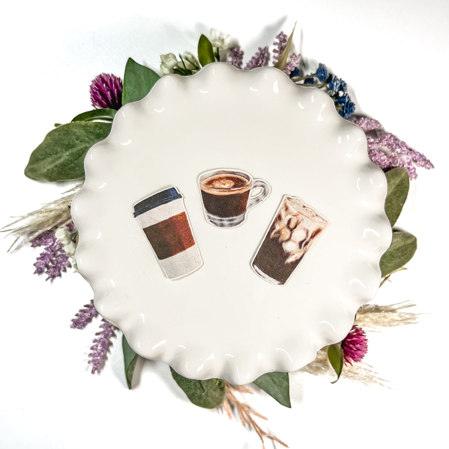 3 Mini Coffee Stickers featuring hand drawn Espresso, Iced Coffee, and a To-Go Cup sitting on top of a mini cake stand surrounded by flowers and greenery