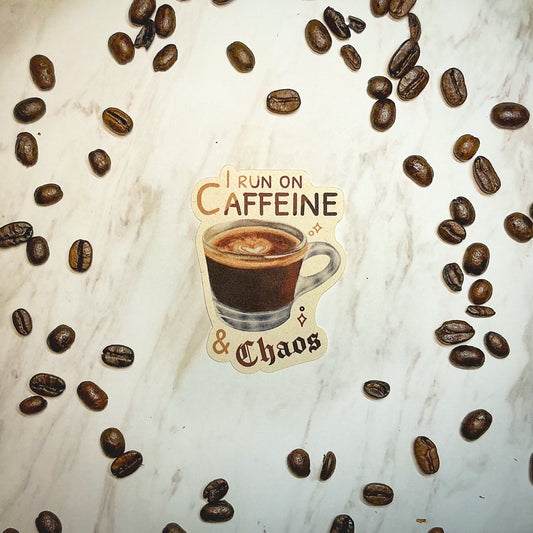 I Run On Caffeine & Chaos Die-Cut Sticker. This handmade coffee sticker features a hand drawn watercolor espresso shot with the words 'I run on caffeine & chaos'. Approximate size (WxH): 3 x 2.4 in. 100% Compostable, Biodegradable, and Recyclable. Printed with water-based ink on Compostable Natural Sugarcane Sticker Paper. Suitable for Home Compost Systems. NOT water resistant or waterproof.