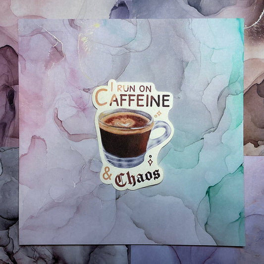 I Run On Caffeine & Chaos Die-Cut Sticker. This handmade coffee sticker features a hand drawn watercolor espresso shot with the words 'I run on caffeine & chaos'. Approximate size (WxH): 3 x 2.4 in. 100% Compostable, Biodegradable, and Recyclable. Printed with water-based ink on Compostable Natural Sugarcane Sticker Paper. Suitable for Home Compost Systems. NOT water resistant or waterproof.